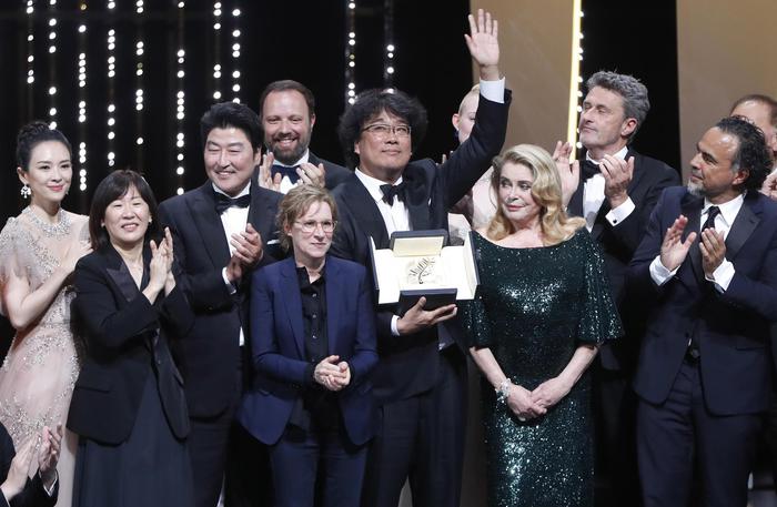 epa07600436 South Korean director Bong Joon-ho (C) winner of the Palme d'Or (Golden Palm) for the movie 'Parasite' on stage during the Closing Awards Ceremony of the 72nd Cannes Film Festival, in Cannes, France, 25 May 2019. The Golden Palm winning movie will be screened after the closing ceremony.  EPA/GUILLAUME HORCAJUELO